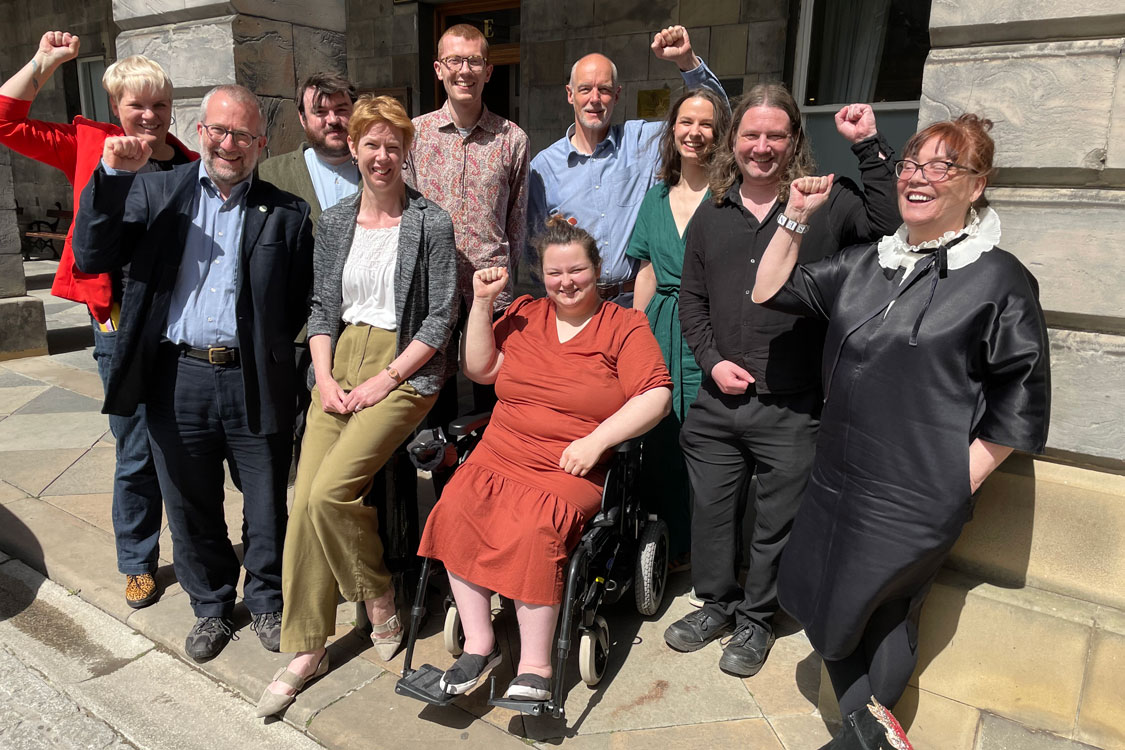 Edinburgh 10 Green councillors at City Chambers, some raising fist and big smiles