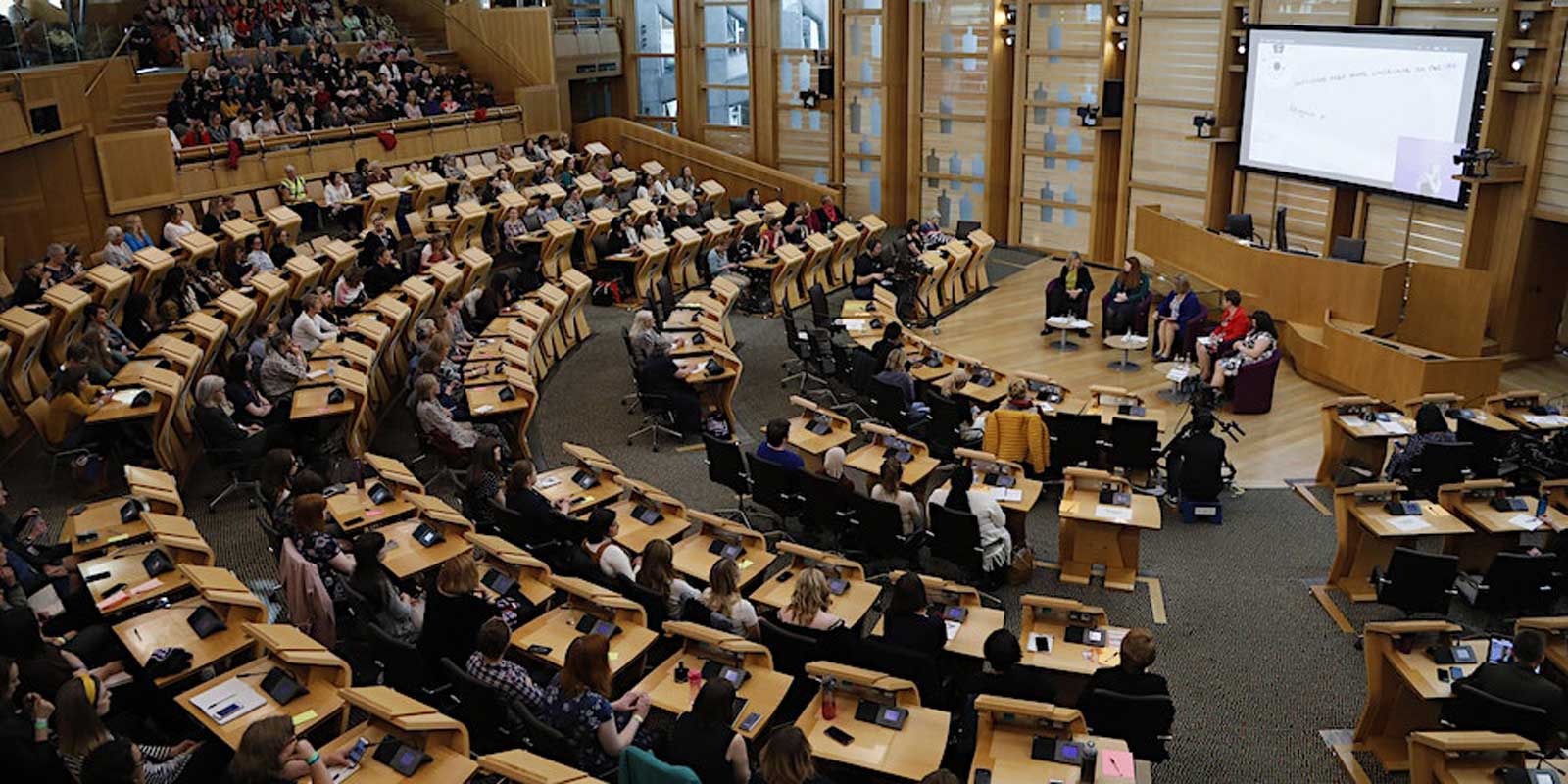 Scottish Parliament debating chamber filled with women