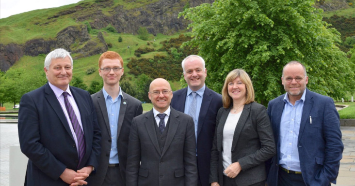 Six Green MSPs with Holyrood Park in background